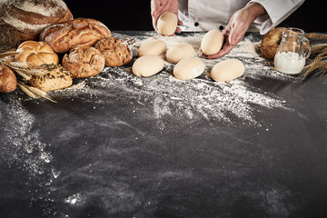 Baker or chef forming rolls from raw dough