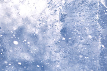 Texture of ice in winter. Pieces of frozen water on a street in the winter. The texture and texture of the frozen water in winter and outdoors.