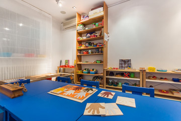 Kindergarten tables with a lot of object. Preschool classroom interior