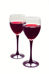 Two glasses of red wine on a white background.
