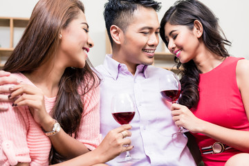 Pretty women enjoying drinks with young man
