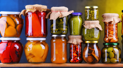 Jars with variety of pickled vegetables and fruits