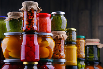 Jars with variety of pickled vegetables and fruits