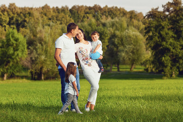 Happy family with children are walking in the park. 