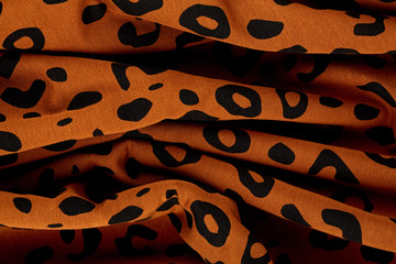 Cotton fabric with animal print. Animal pattern background or texture. Texture leopard.