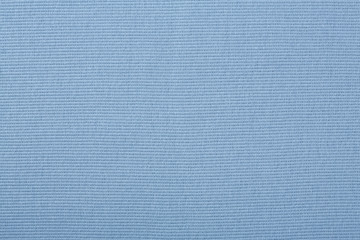 Blue cotton textile - close up of fabric texture. Cotton Fabric Texture. Top View of Cloth Textile Surface. Blue Clothing Background. Text Space. Abstract background and texture for designers.