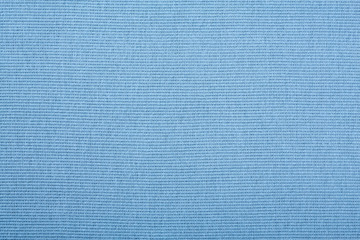 Blue cotton textile - close up of fabric texture. Cotton Fabric Texture. Top View of Cloth Textile Surface. Blue Clothing Background. Text Space. Abstract background and texture for designers.