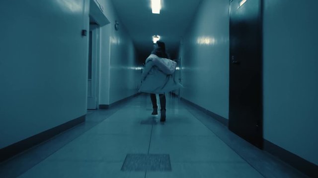 The girl drops her jacket and escapes from the attacker in the side aisle. The clock on the wall shows five minutes to eleven in the pm.