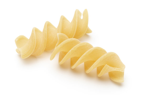 Italian twisted pasta fusilli isolated on white background. Fusilloni, rotini.