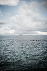Obraz premium Dramatic view of the horizon on a rainy day from the tourist port of Ortigia in Syracuse.