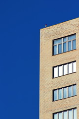 Modern brick office building on a background of clear blue sky.