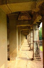 An open stone gallery illuminated by the sun in the ancient Angkor Wat temple in Siem Reap, Cambodia. World Heritage Site by UNESCO. Ancient Khmer architectural monument