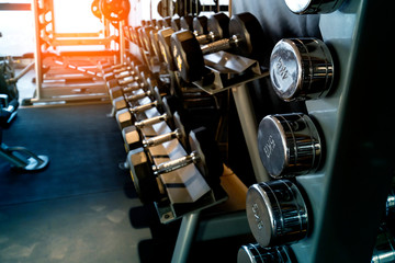 row of dumbbell in gym fitness center