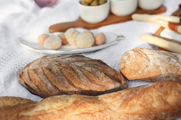 fresh baked bread on white blanket. bakery concept