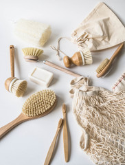 Fototapeta na wymiar Dish washing brushes, bamboo toothbrushes, reusable bags. Sustainable lifestyle zero waste concept. Clean without waste. No plastic objects.