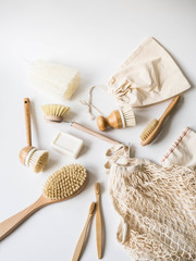 Fototapeta na wymiar Dish washing brushes, bamboo toothbrushes, reusable bags. Sustainable lifestyle zero waste concept. Clean without waste. No plastic objects.
