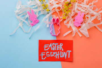 Handmade Easter decor items, top view. Easter egg hunt paper card. Silicone rabbit shape molds and...