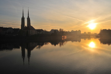 Fototapeta na wymiar Cathedral of St. John the Baptist twin towers Odra river sunset Wroclaw, Poland, Europe