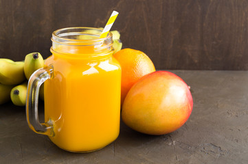 Fresh fruit juice in the jar. on dark background.