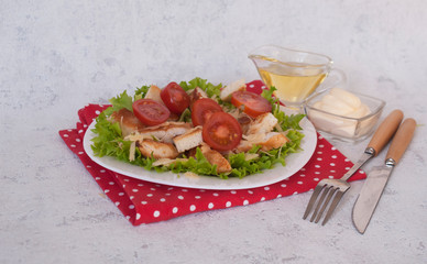 Caesar salad with chicken, cheese, tomatoes and croutons. The concept of a healthy lifestyle.