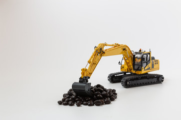 Roasted Coffee bean concept in scoop bucket of excavator loaders model