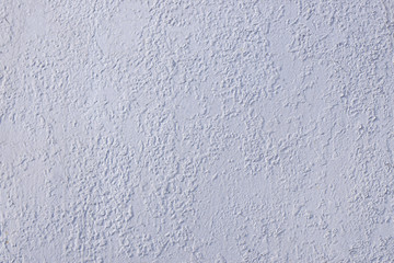 The texture of the flat surface of concrete painted with white paint with drops, drips and irregularities