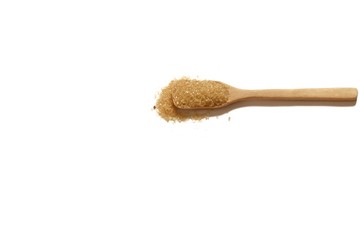 Organic brown sugar in a wooden teaspoon on white isolated background 