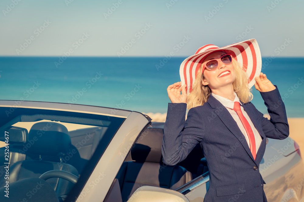 Poster Successful young businesswoman on a beach