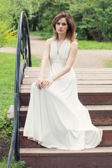 Romantic woman in white dress outdoor