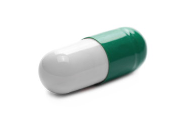 macro green pills, medicine isolated on white background, top view