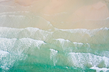 Aerial view, tropical beach, top view of the waves on the beautiful sand beach