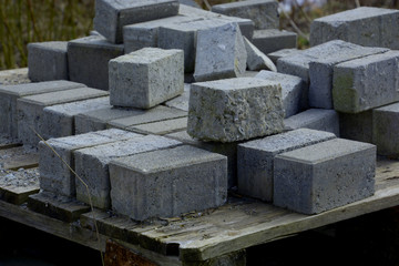 forgotten rough cement blocks as a sign of transience in a lost place, stacked concrete blocks on a...