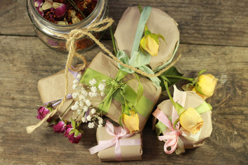 present handmade cosmetics wrapped in papper and flowers