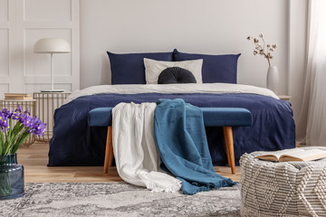 Open book on pouf in contemporary bedroom interior