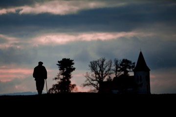 Fototapeta premium Old man on its way to church.