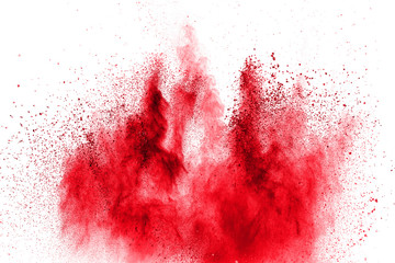 Red powder explosion on white background. Freeze motion of red dust particles splash.