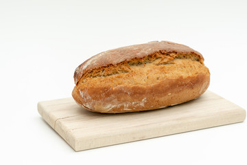 freshly baked bread lies on a wooden board