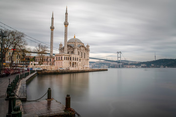 Fototapeta na wymiar Ortakoy Mosque - Day to night time lapse scene of the beautiful renovated Ortakoy mosque in Istanbul with Bosphorus bridge in the background. Turkey