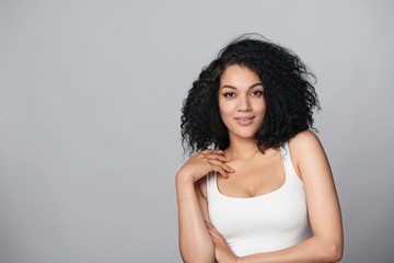 Relaxed mixed race african american - caucasian woman standing in studio