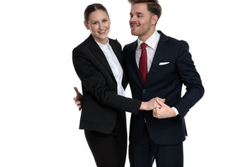 couple in business suits holding hands together
