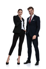couple in business suits holding hands at chin thinking