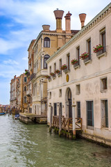 Fototapeta na wymiar Buildings in narrow canal in Venice, Italy