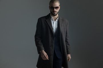 man in suit with sunglasses and longcoat
