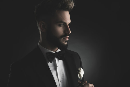 side view of a man in tuxedo looking away