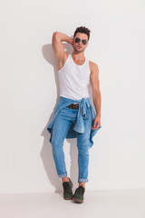 Attractive man posing with a hand behind his neck