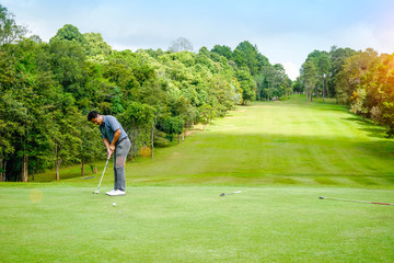 Golfer playing golf in beautiful golf course in the evening golf course with sunshine in thailand
