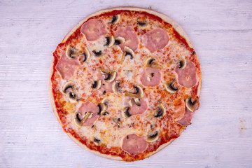 Ham and mushrooms pizza under cheese