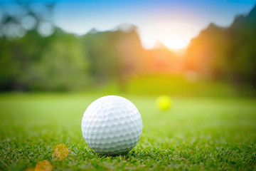 Golf ball on green in beautiful golf course at sunset background. Golf ball on green in golf course at Thailand