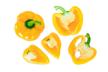 yellow bell pepper cut half into pieces on white background, top view.