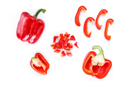 red bell pepper cut into pieces on white background top view.